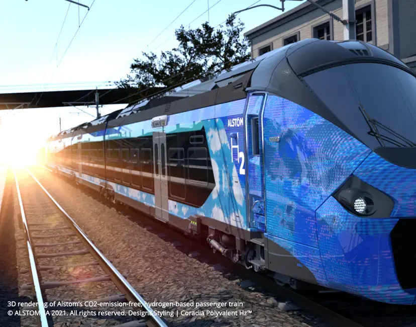 A sleek, blue hydrogen-powered passenger train at a station, with sunlight shining in the background.